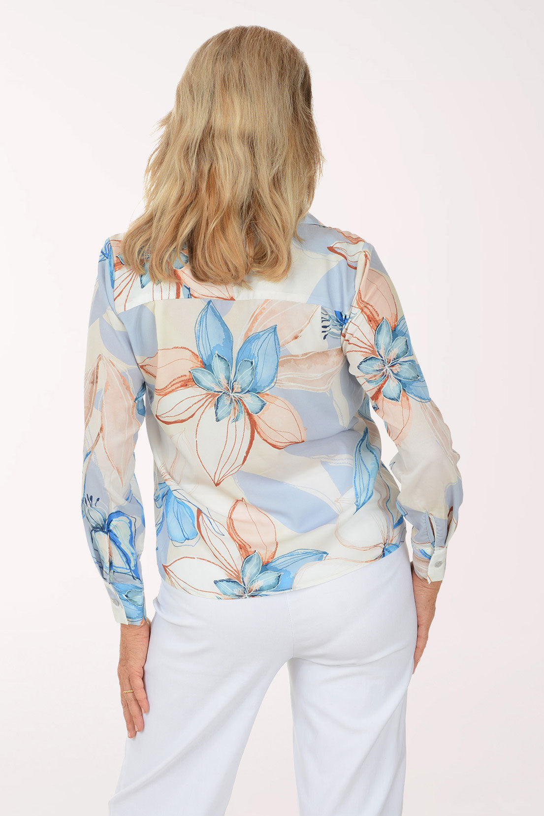 Woman wearing a floral blouse with a white background