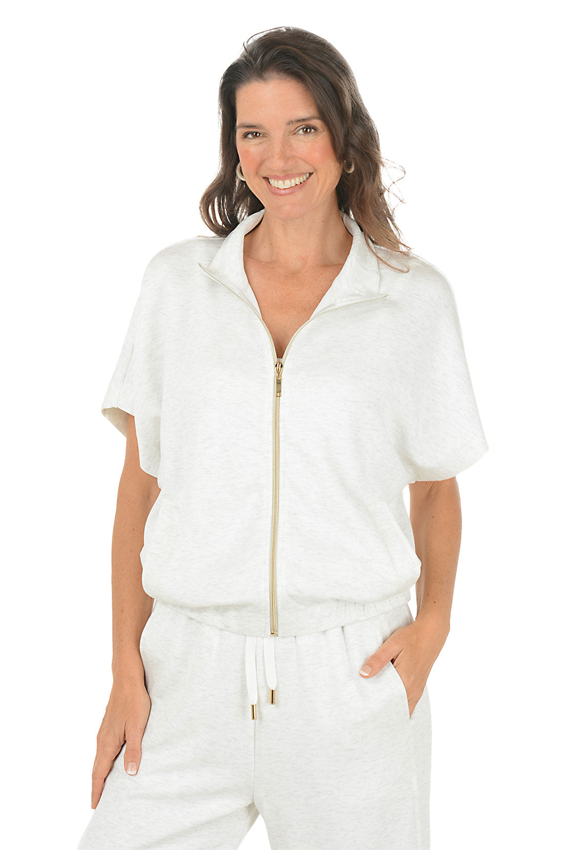 Woman wearing a white blue zip-up top with a white background.