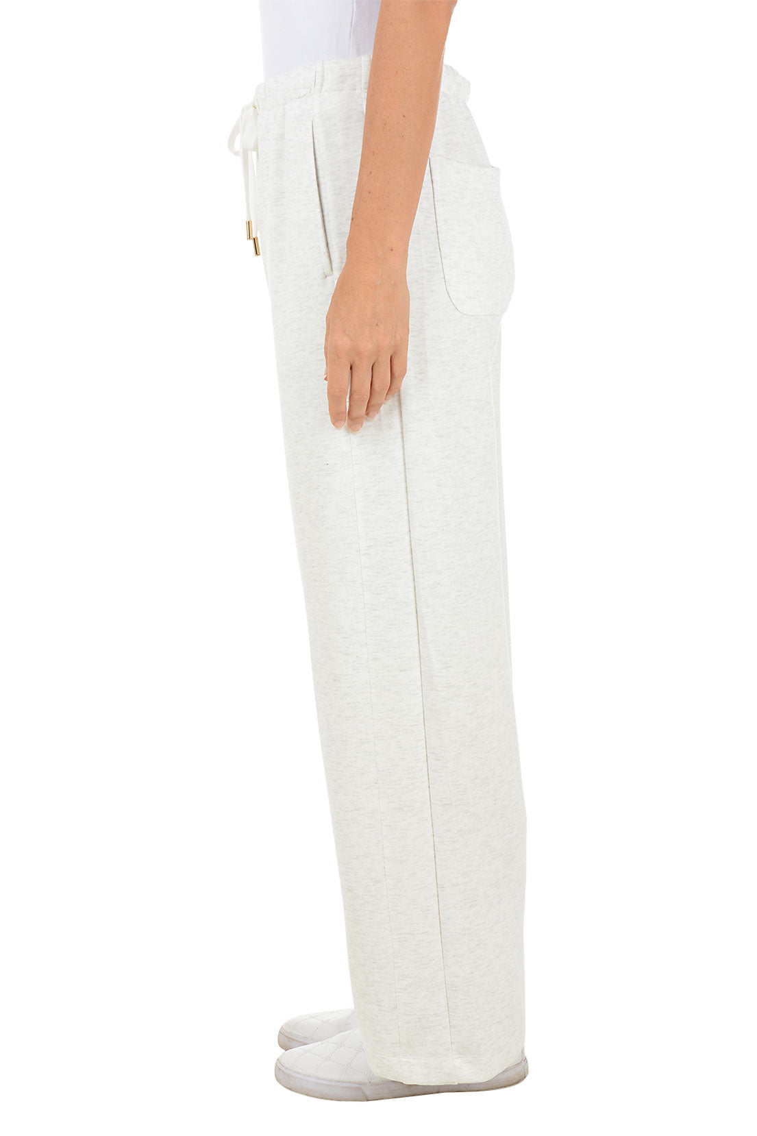 White wide leg sweat pants worn by a person on a white background. Side shot.
