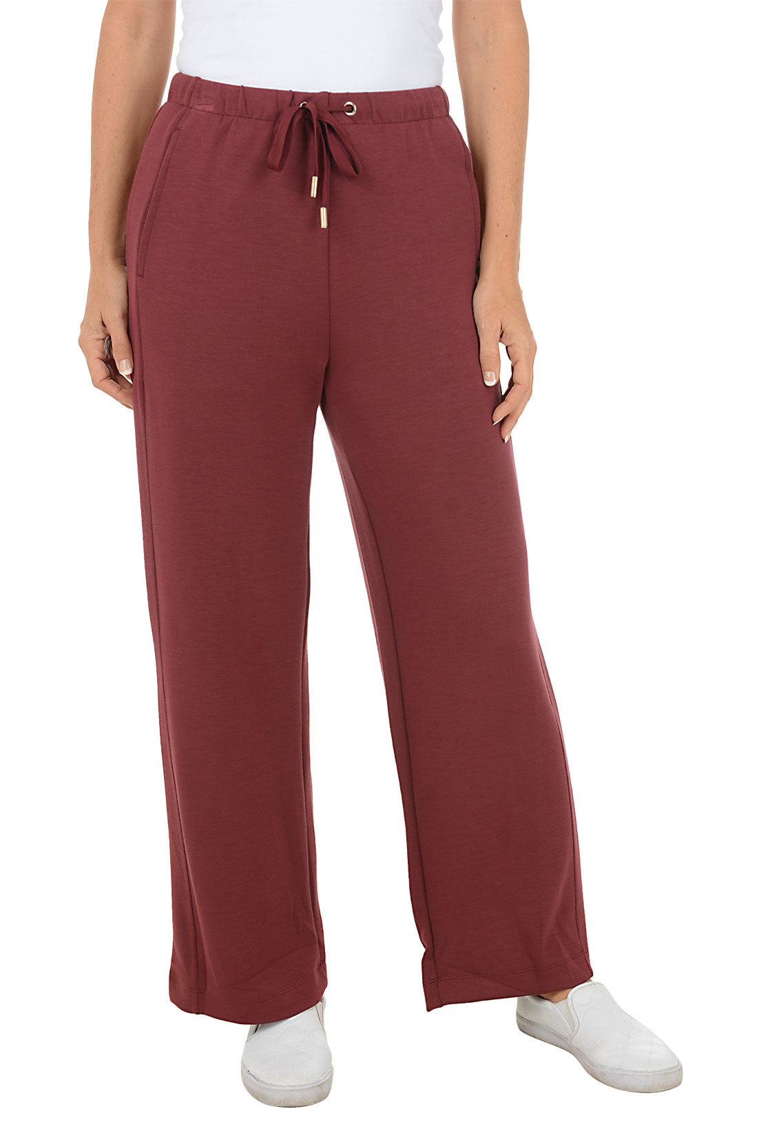 Maroon wide leg sweat pants worn by a person on a white background.