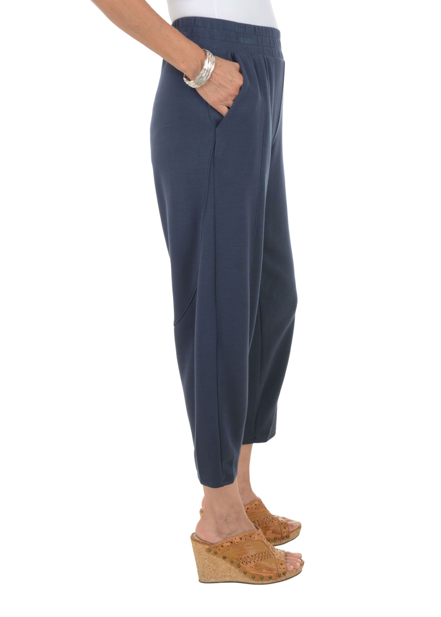 Navy blue pants worn by a person on a white background