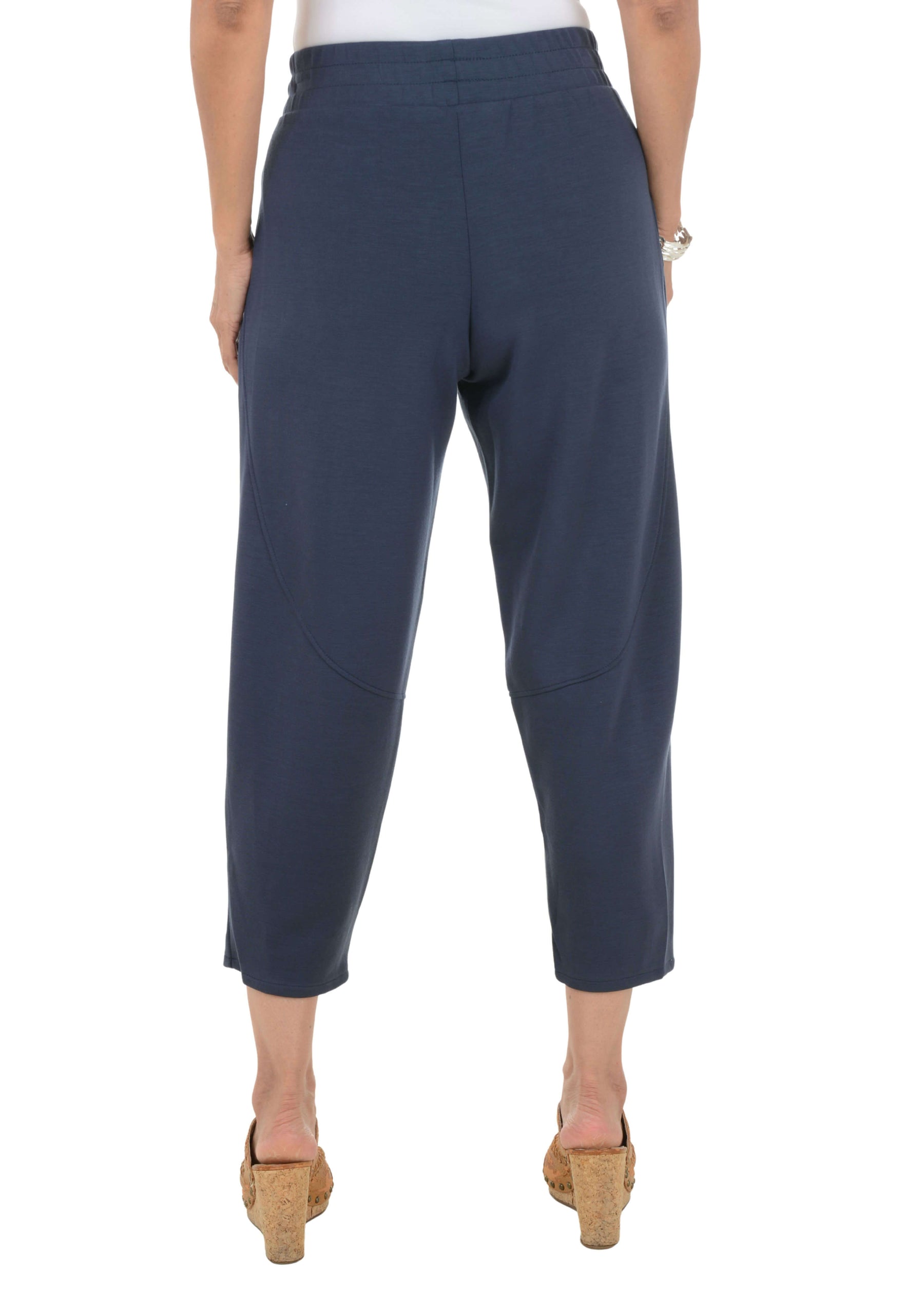 Navy blue pants worn by a person on a white background