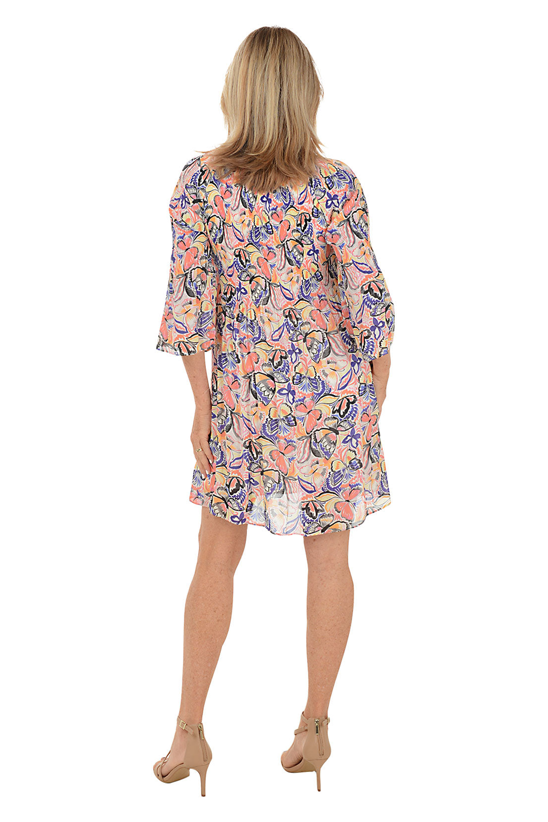 A back shot of a model wearing a floral print, keyhole neckline, pleated dress with 3/4 bell sleeves.