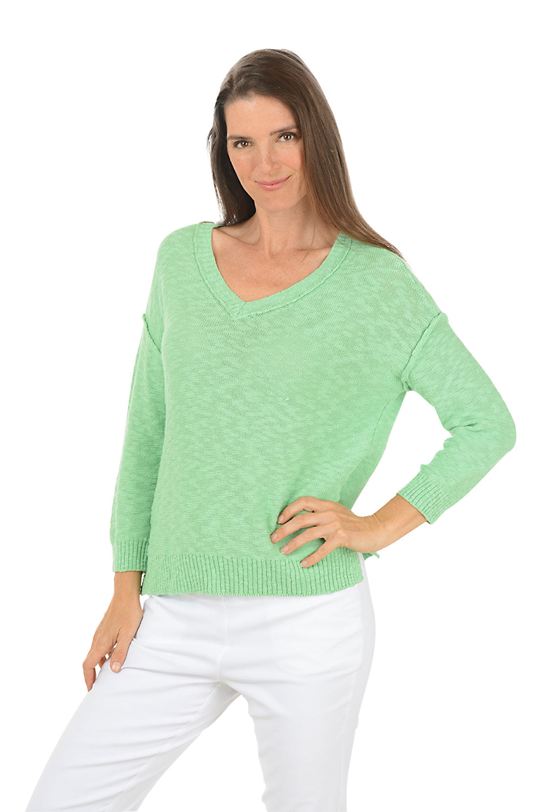 Model wearing a light green V-neck knit top with three-quarter sleeves and white pants.