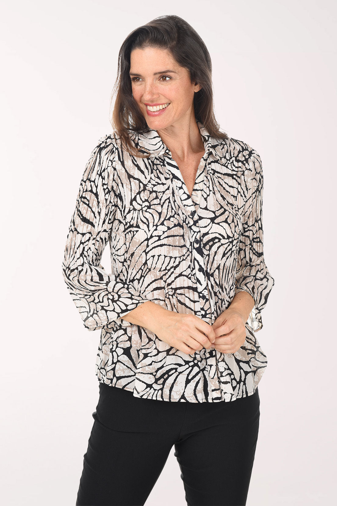 Woman wearing a patterned blouse on a white background