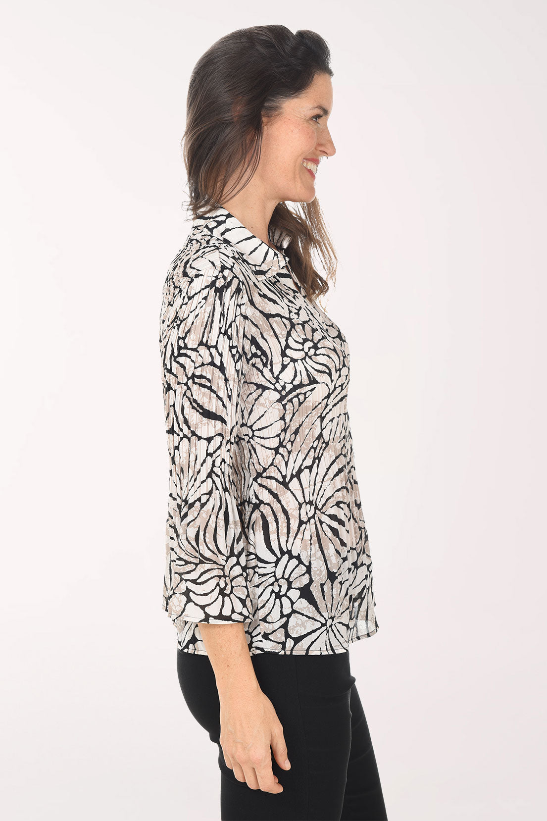 Woman wearing a patterned blouse on a white background
