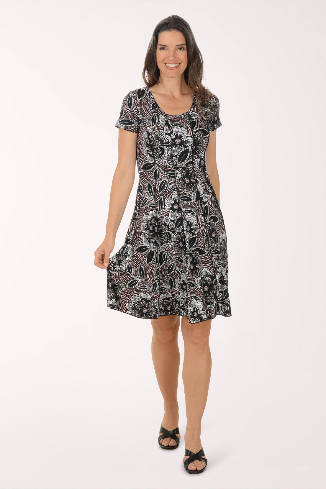Woman wearing a patterned dress on a white background