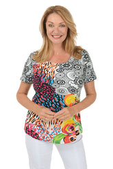 A front shot of a model wearing a short sleeve t-shirt with a geometric and floral pattern, in a multicolor print.