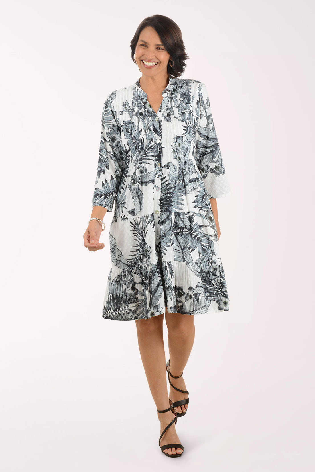 Woman wearing a black and white patterned dress on a white background