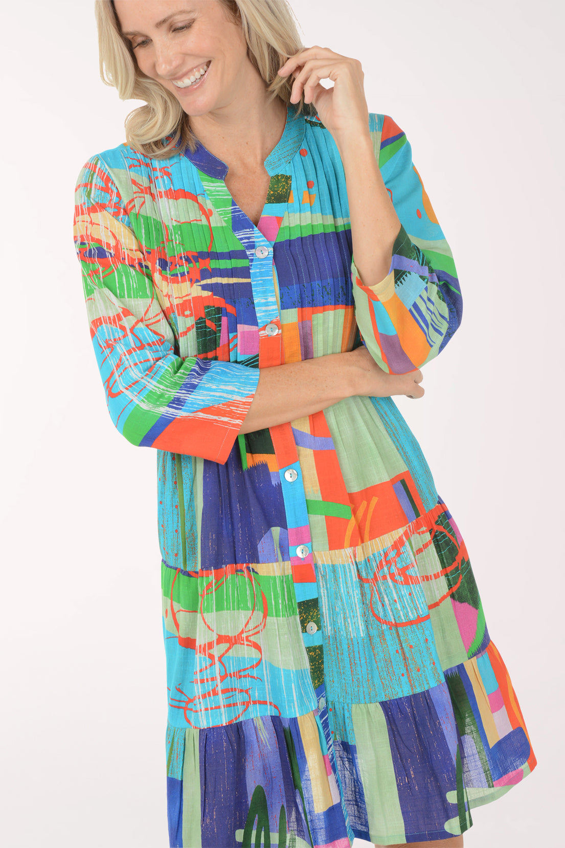 Woman wearing a colorful patterned dress on a white background