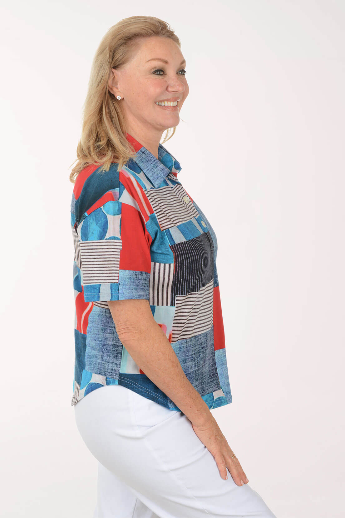 Woman wearing a colorful patchwork shirt on a white background