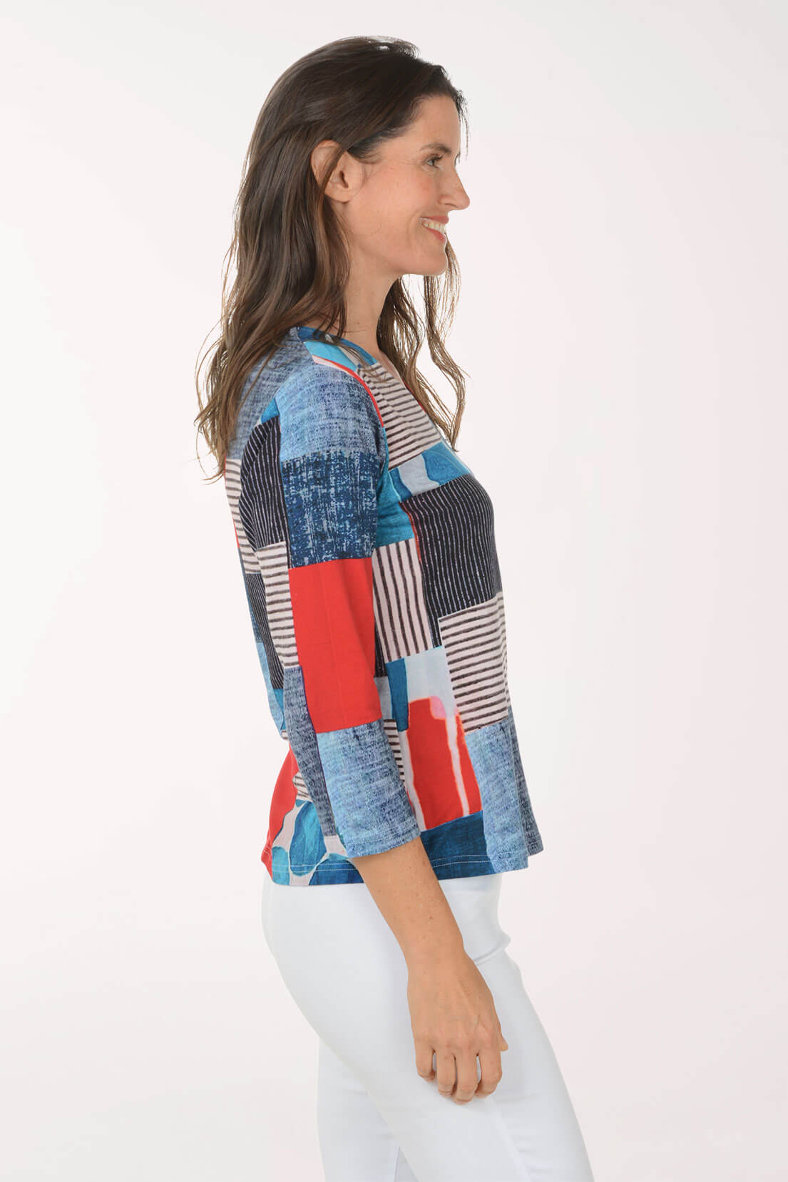 Woman wearing a colorful patchwork shirt on a white background