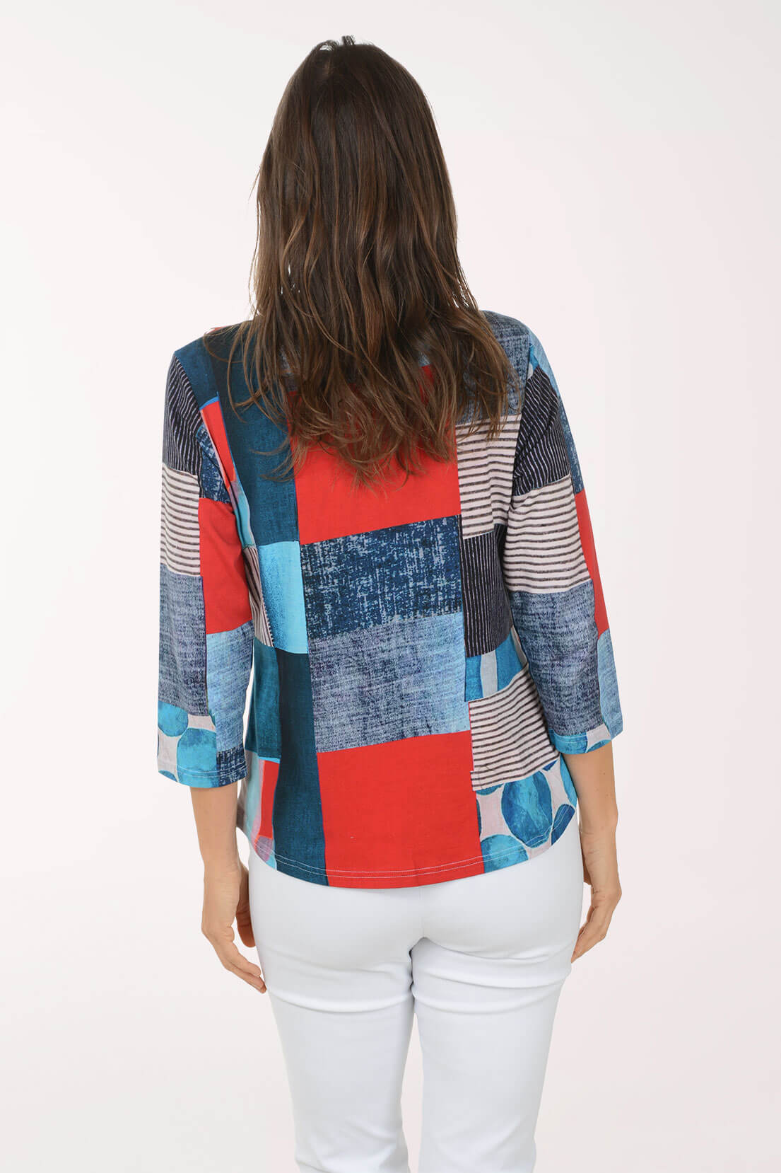 Woman wearing a colorful patchwork shirt on a white background