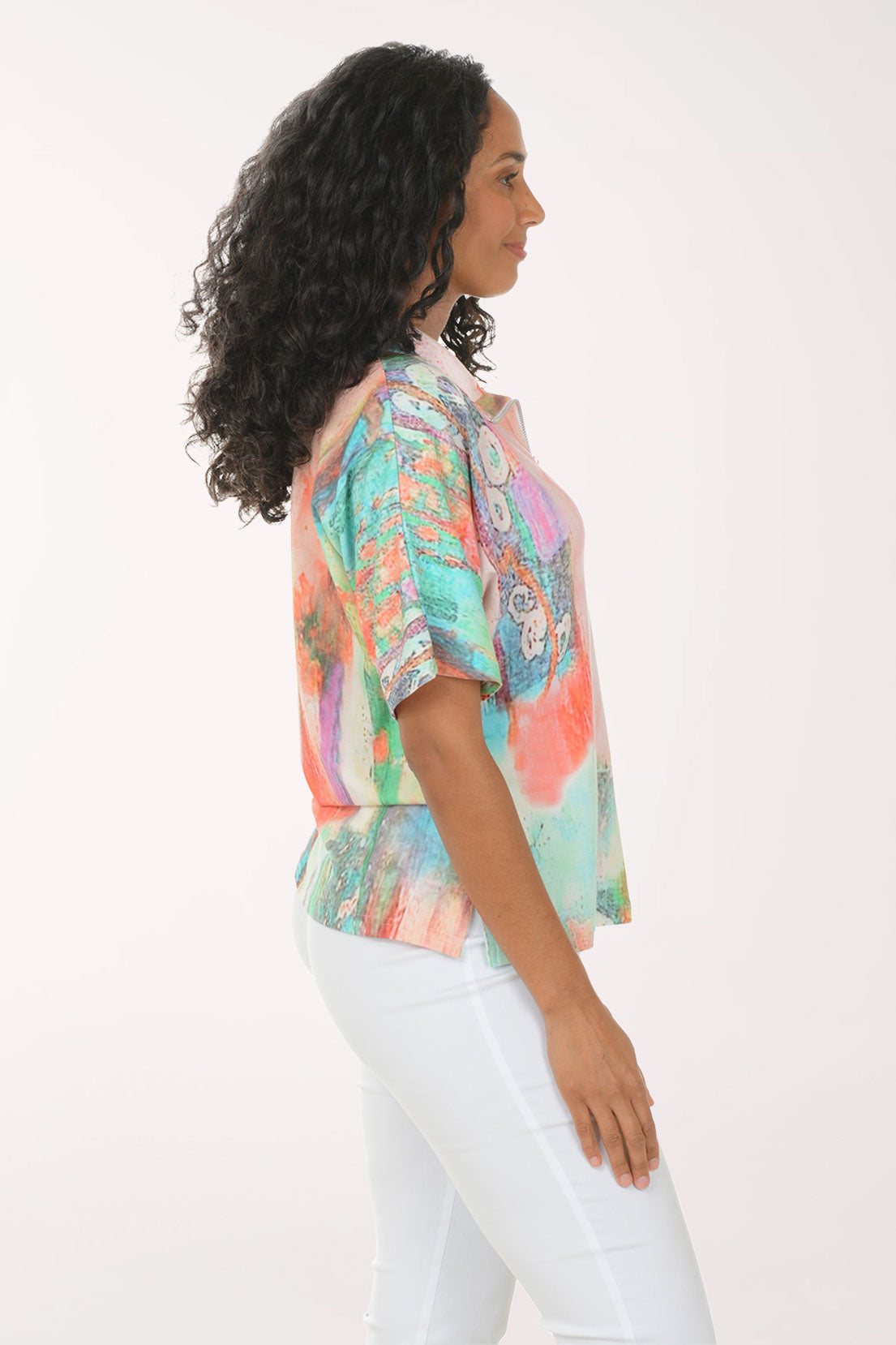 Woman wearing a colorful blouse with a white background
