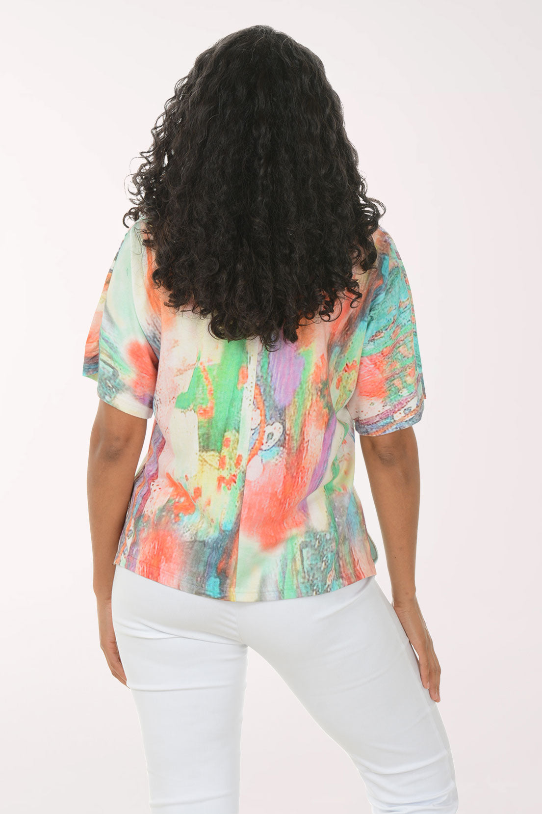 Woman wearing a colorful blouse with a white background