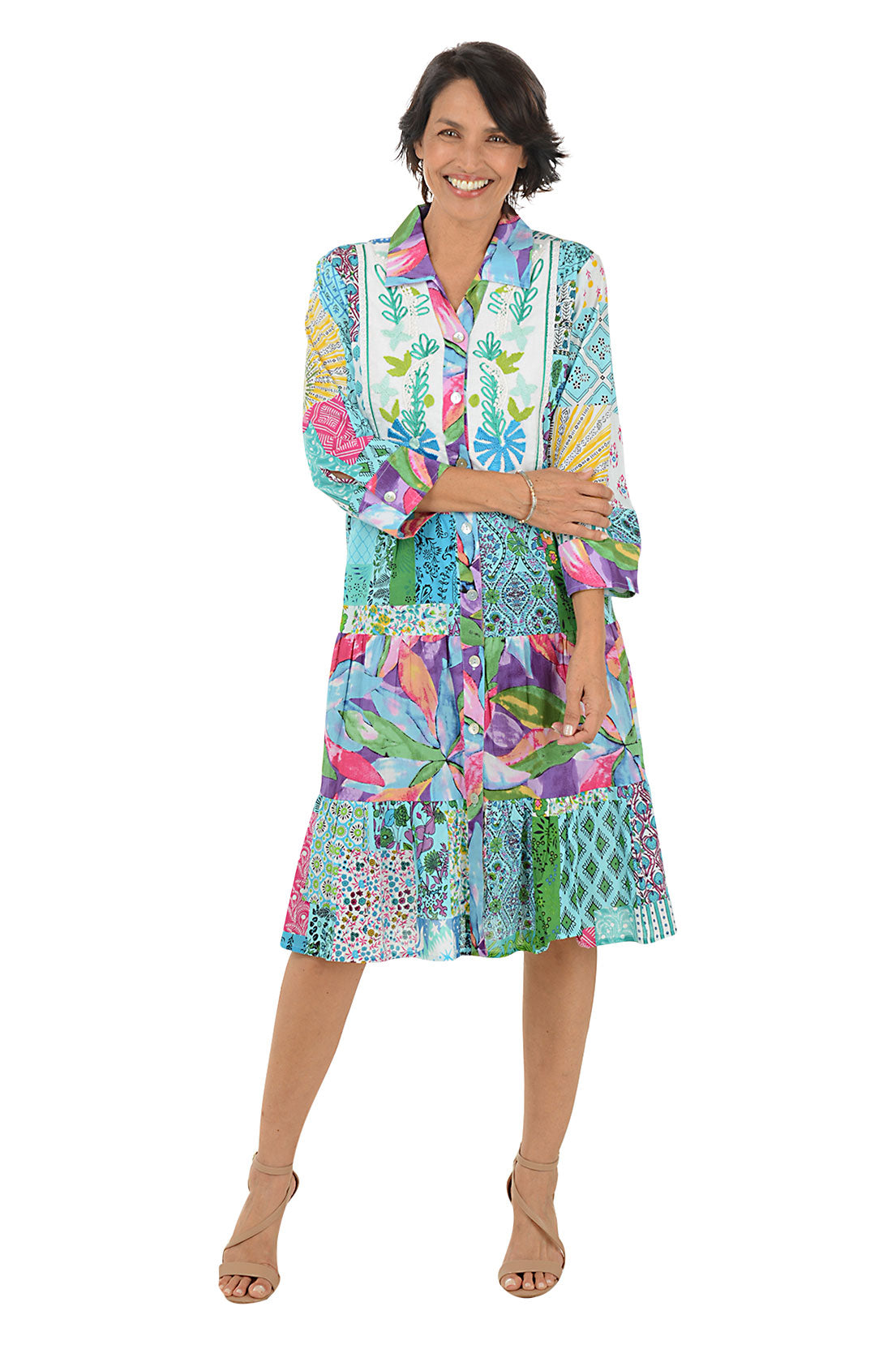 Woman wearing a colorful patterned dress on a white background