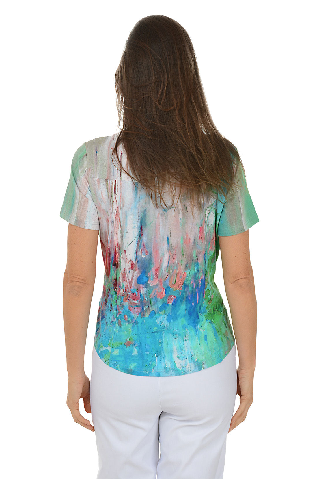 Woman wearing a colorful top with abstract design on a white background. Side shot.