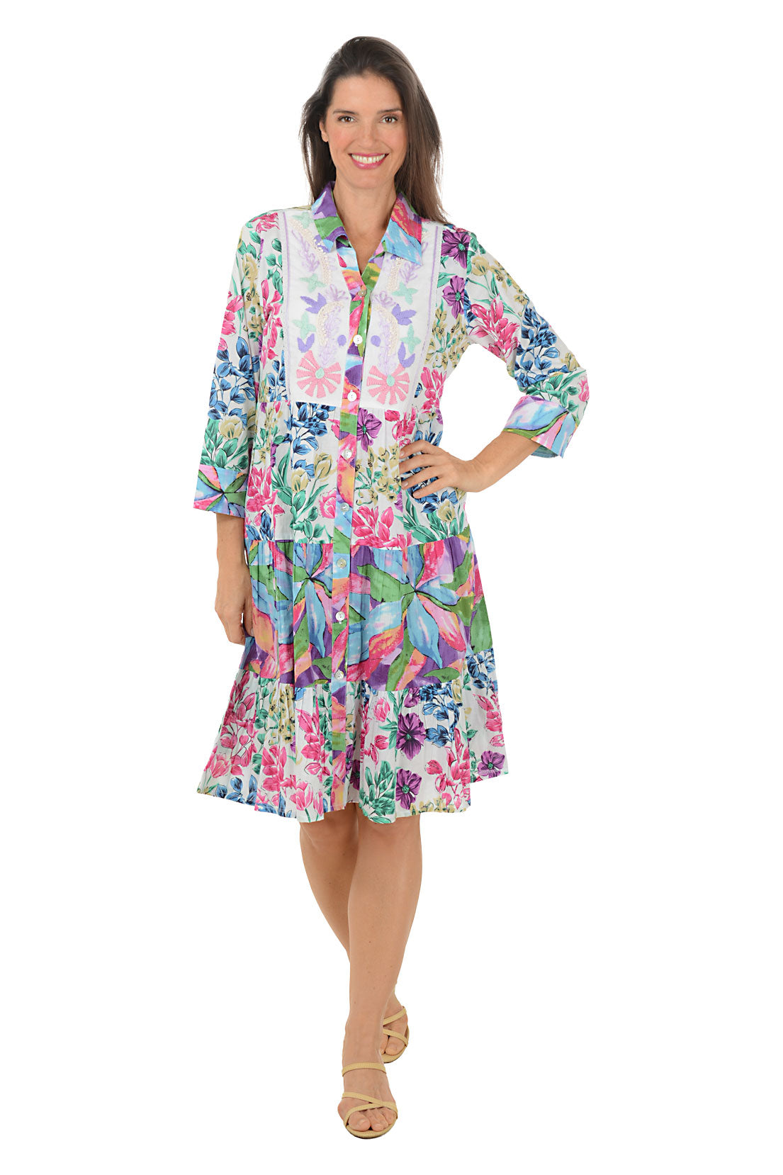 Woman wearing a colorful floral dress on a white background