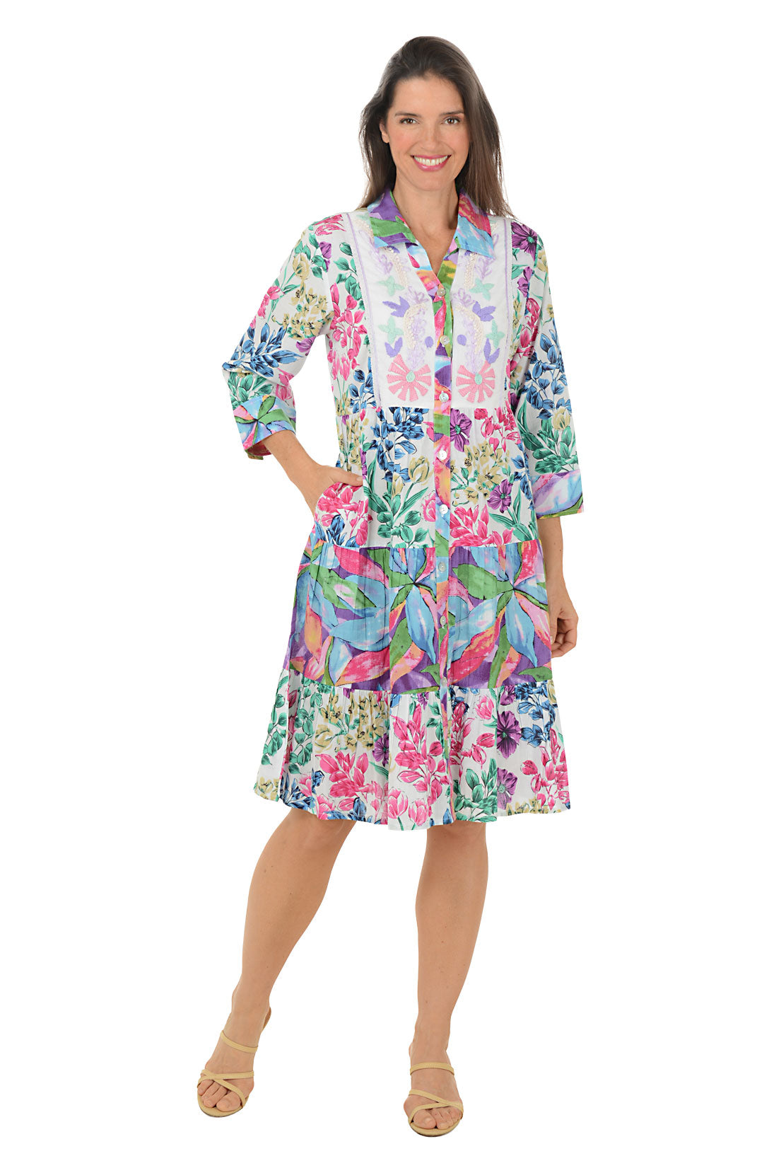Woman wearing a colorful floral dress on a white background