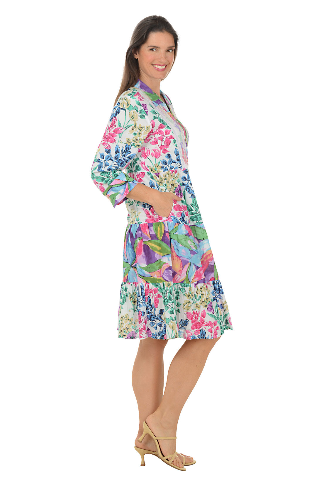 Woman wearing a colorful floral dress on a white background