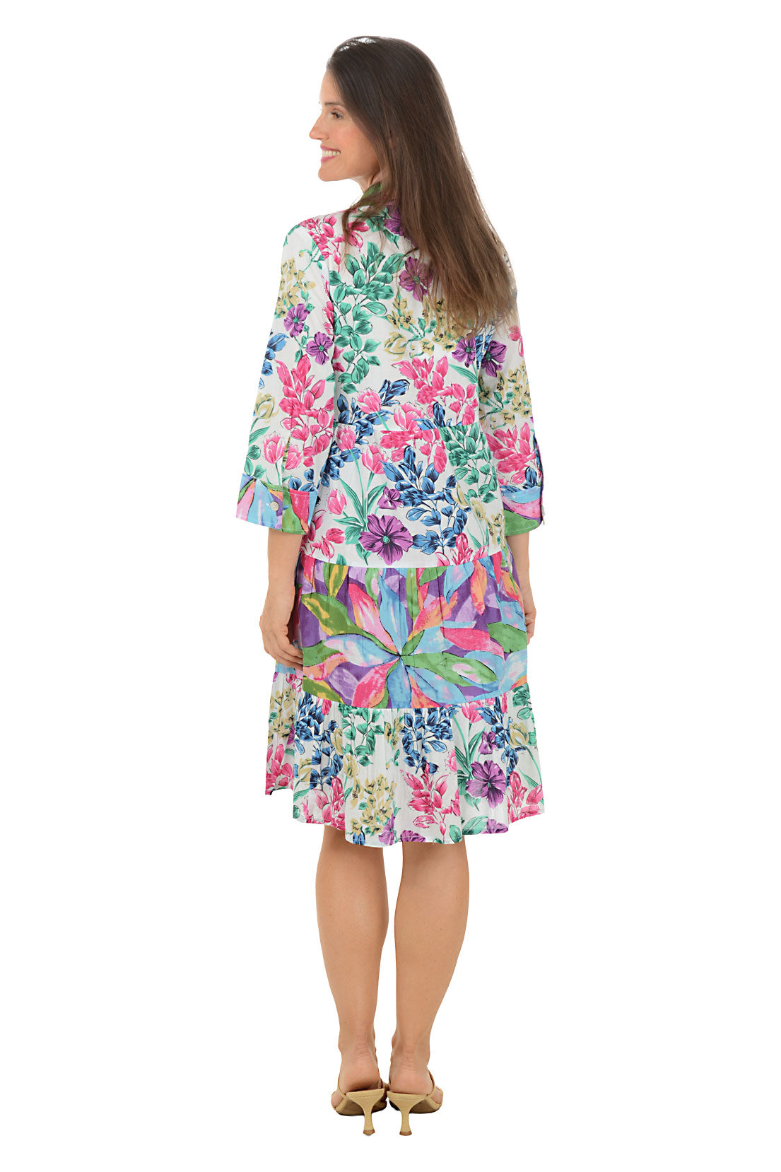 Woman wearing a colorful floral dress on a white background