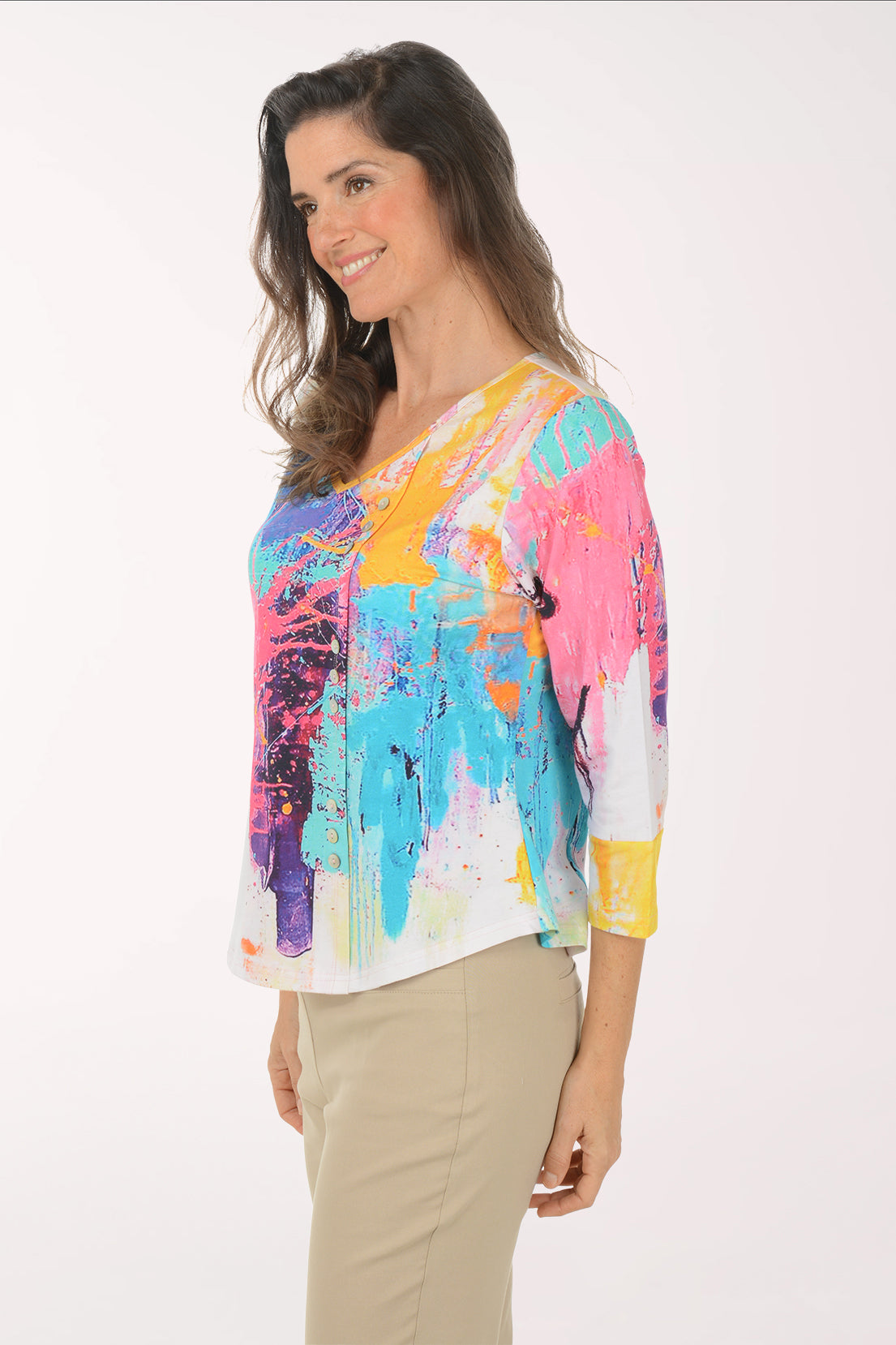 Woman wearing a multicolored 3/4 sleeve top.