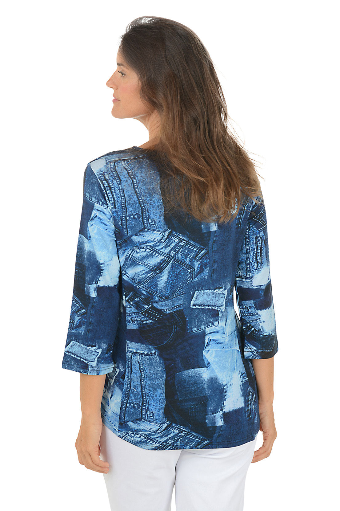 Woman wearing a 3/4 sleeve blue patterned top with white pants on a white background. Back shot.