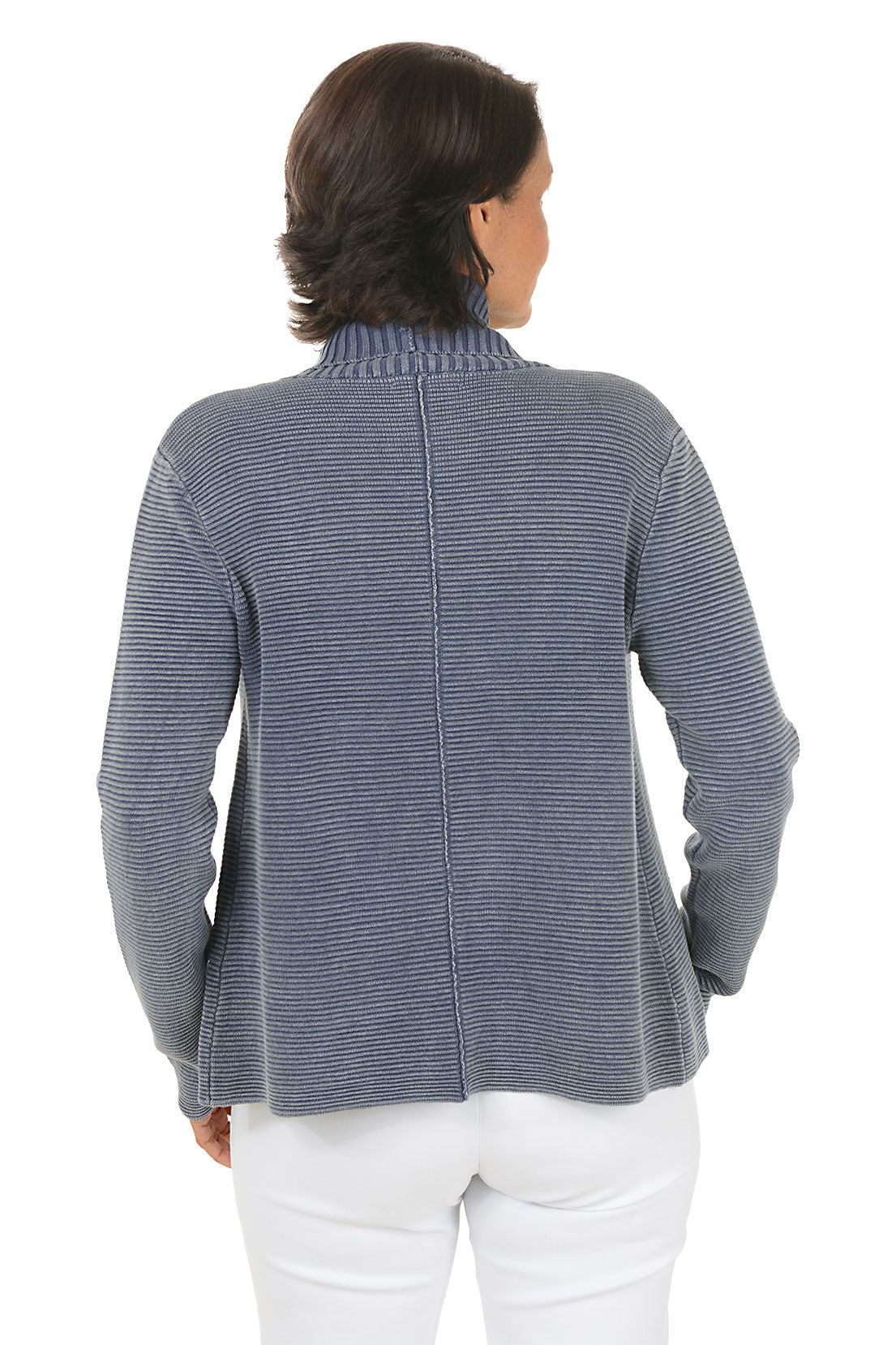 Woman wearing a blue knitted cardigan over a white top on a white background. Back shot.