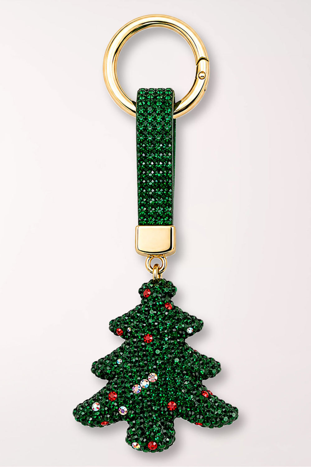 A green rhinestone Christmas tree bag charm with colorful rhinestone ornaments, on a green rhinestone strap with a gold ring.