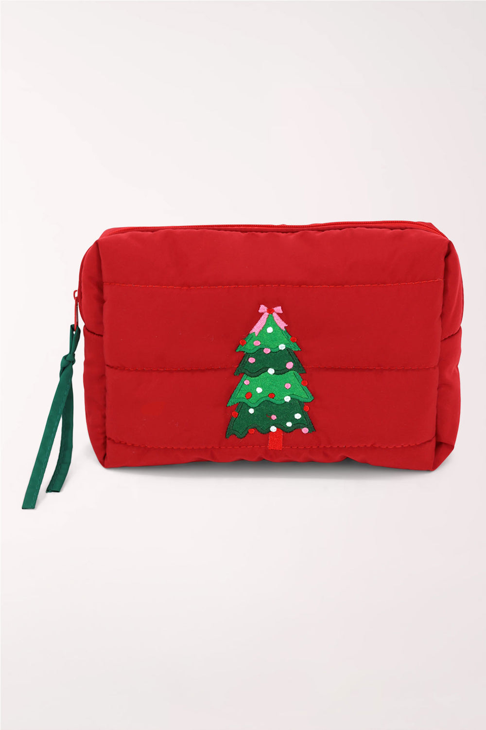 A red quilted cosmetics pouch with an embroidered green Christmas tree decorated with ornaments and a pink bow on top.