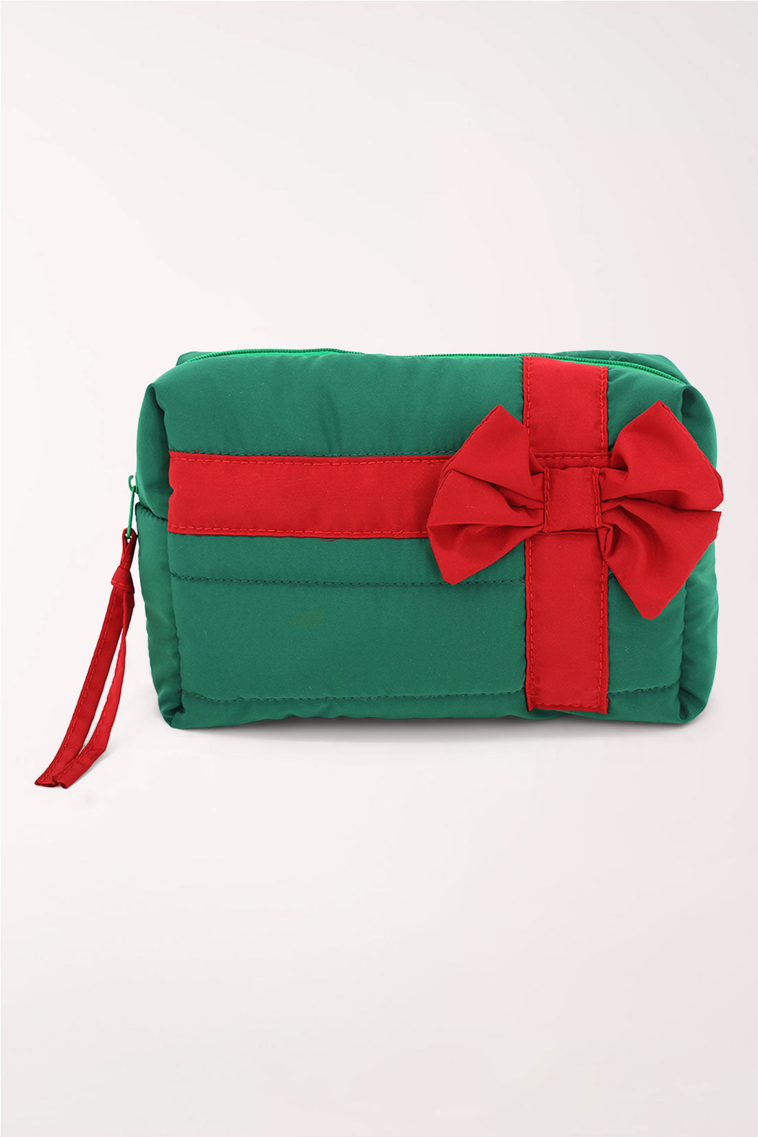 A green quilted cosmetics pouch wrapped with a red ribbon and bow like a present, with a red zipper pull.