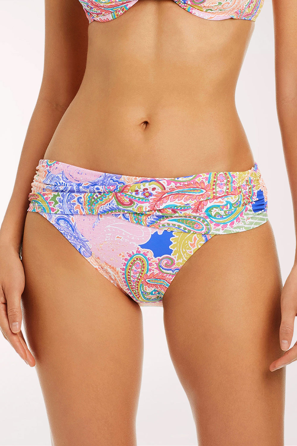 Close-up front view of the La Vida Bohemia Sarong Hipster Bikini Bottom in a paisley patchwork print in pink, lavender, lime green, coral and cobalt blue, with a wide wrapped sarong-style waistband and full-coverage cut.