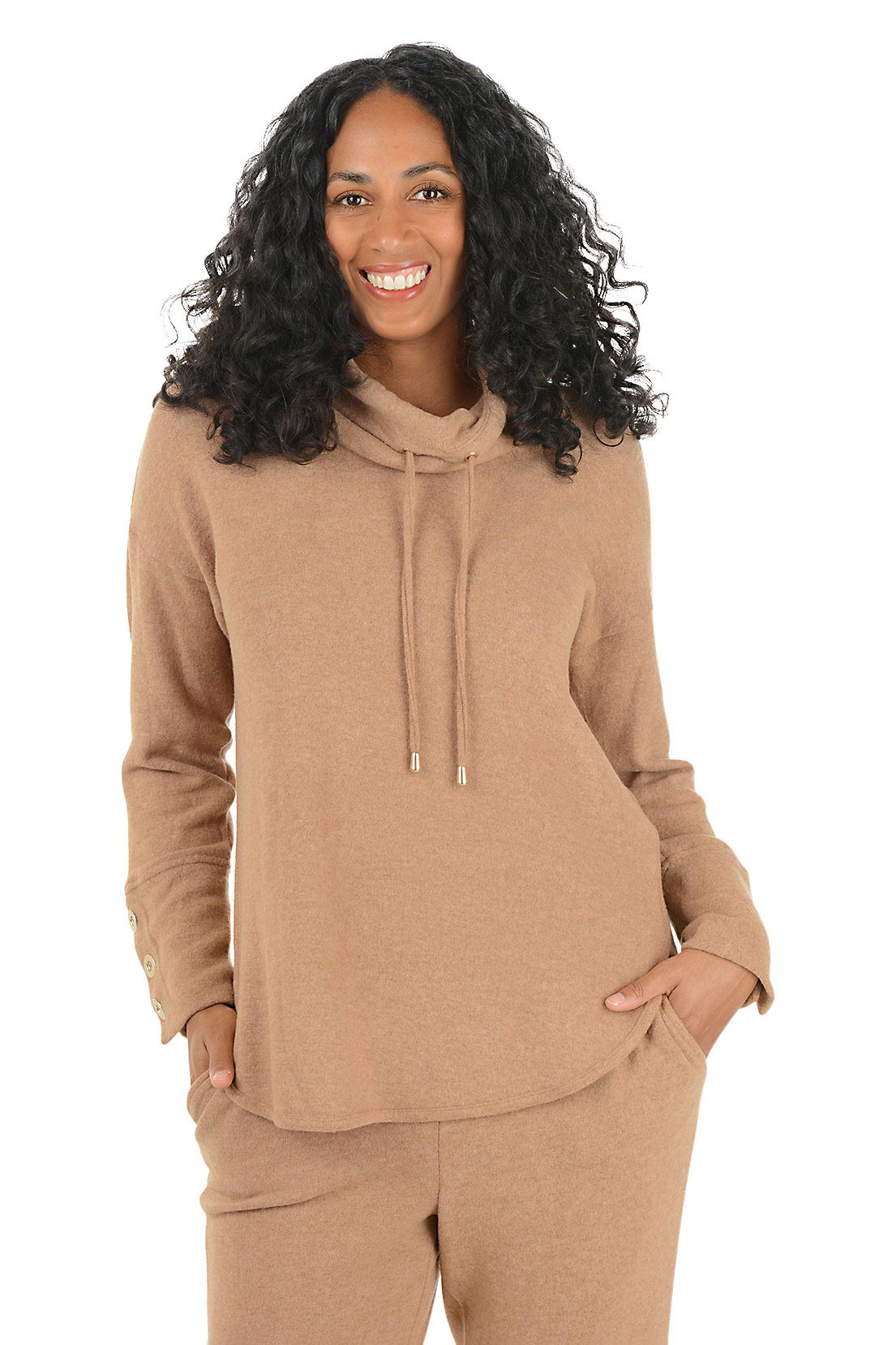 Woman wearing a beige hoodie with button details on the arm on a white background.