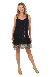 A front shot of a model wearing a sleeveless navy dress with gold-accented floral embroidery and a double-tiered ruffled hem. The dress features a V-neckline, offset buttons, and a surplice detail at the front.