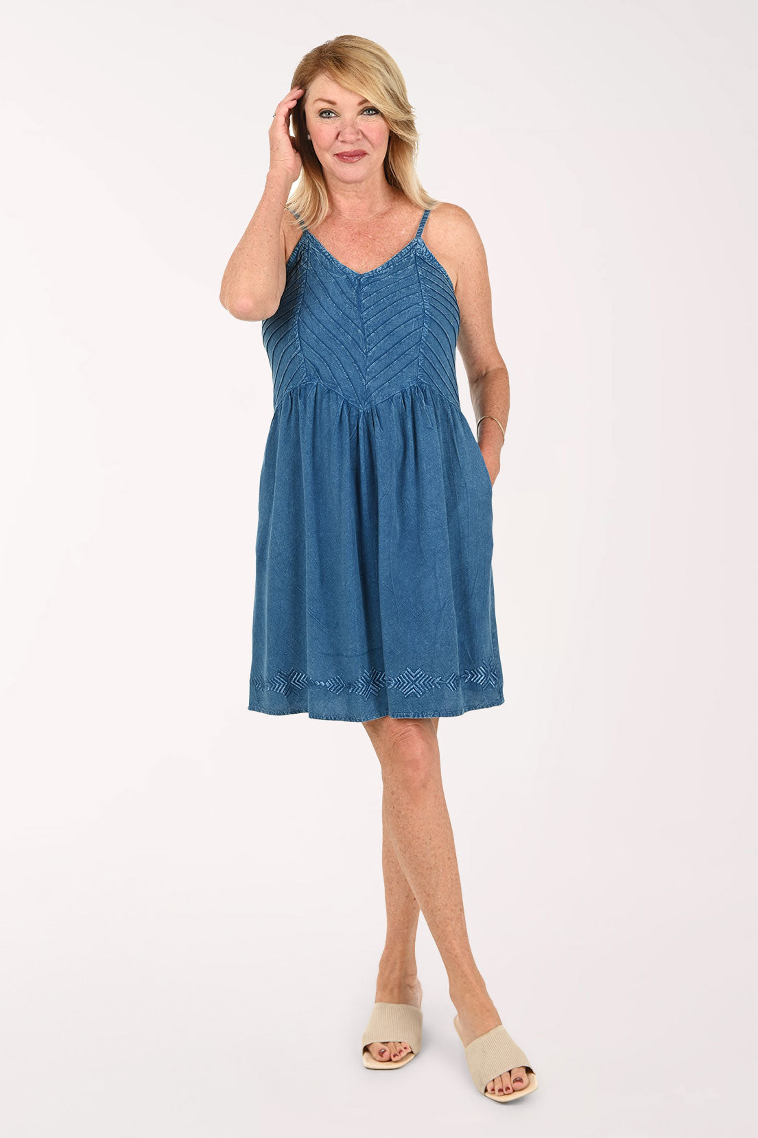 Woman wearing a sleeveless blue dress