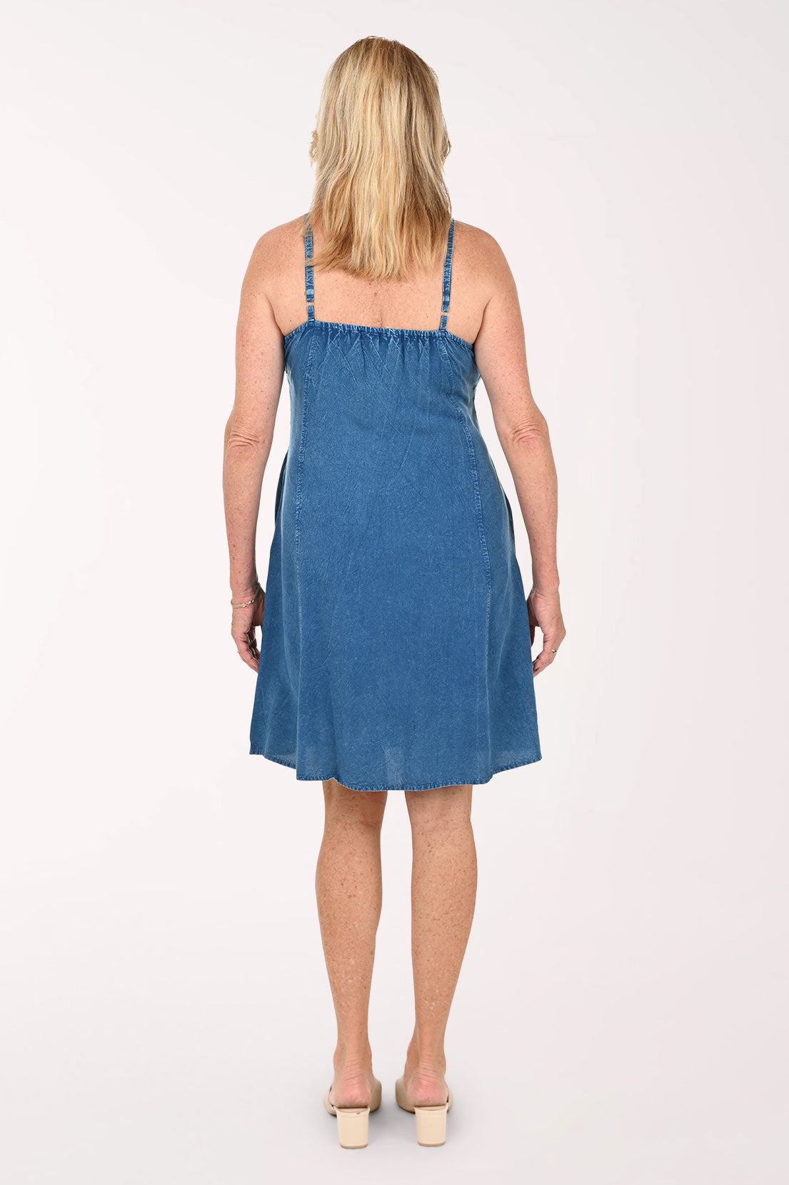 Woman wearing a sleeveless blue dress