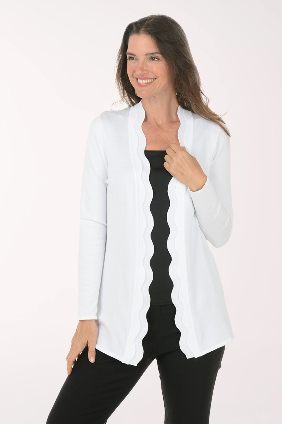 Woman wearing a white cardigan over a black top on a white background