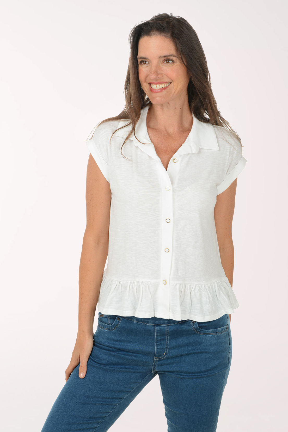 Woman wearing a white blouse and blue jeans on a white background