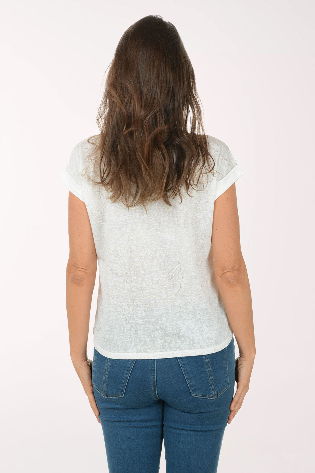 Woman wearing a white short-sleeve top and blue jeans on a white background