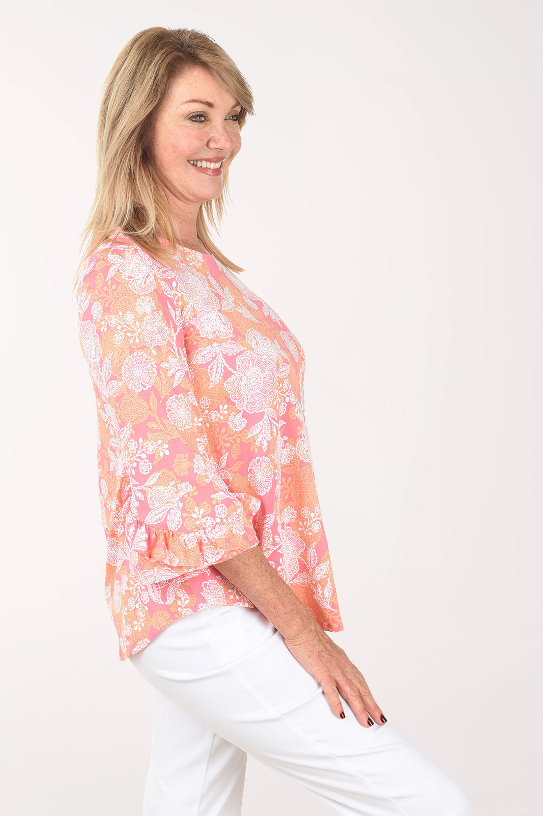 Woman wearing a floral blouse with a white background