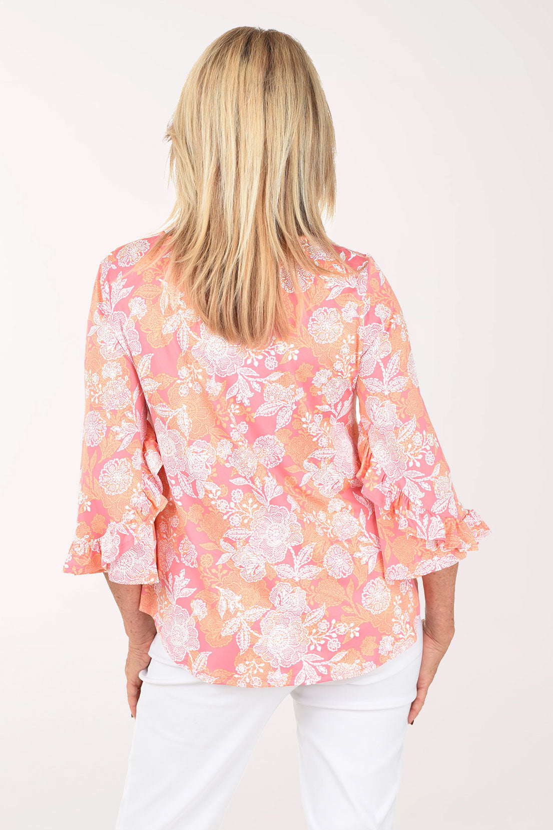 Woman wearing a floral blouse with a white background