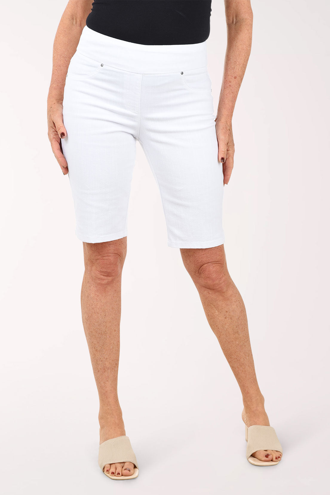 White shorts worn by a person on a white background