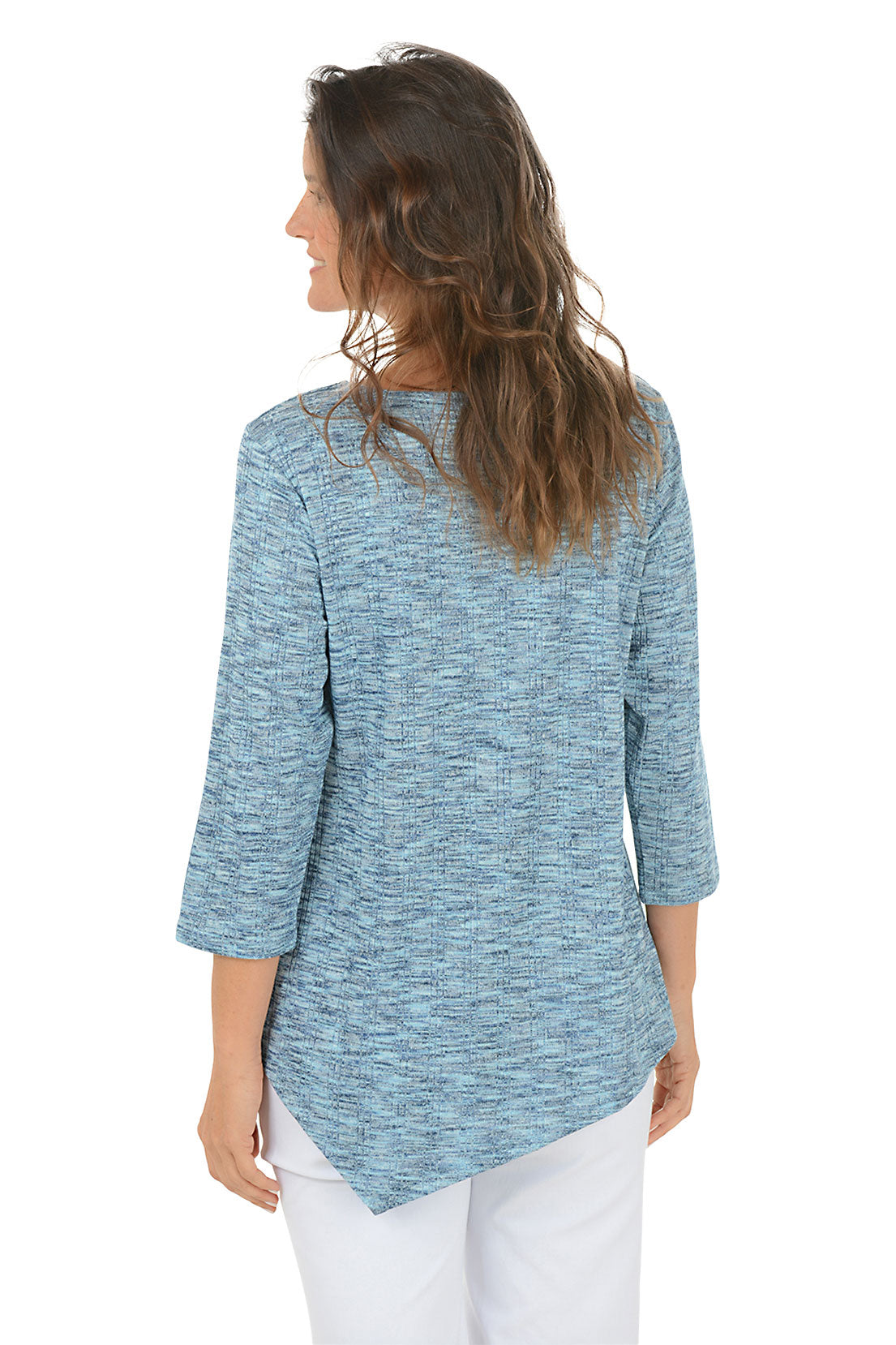 Woman wearing a blue knit top with an asymmetrical handkerchief hemline on white background. Back shot.