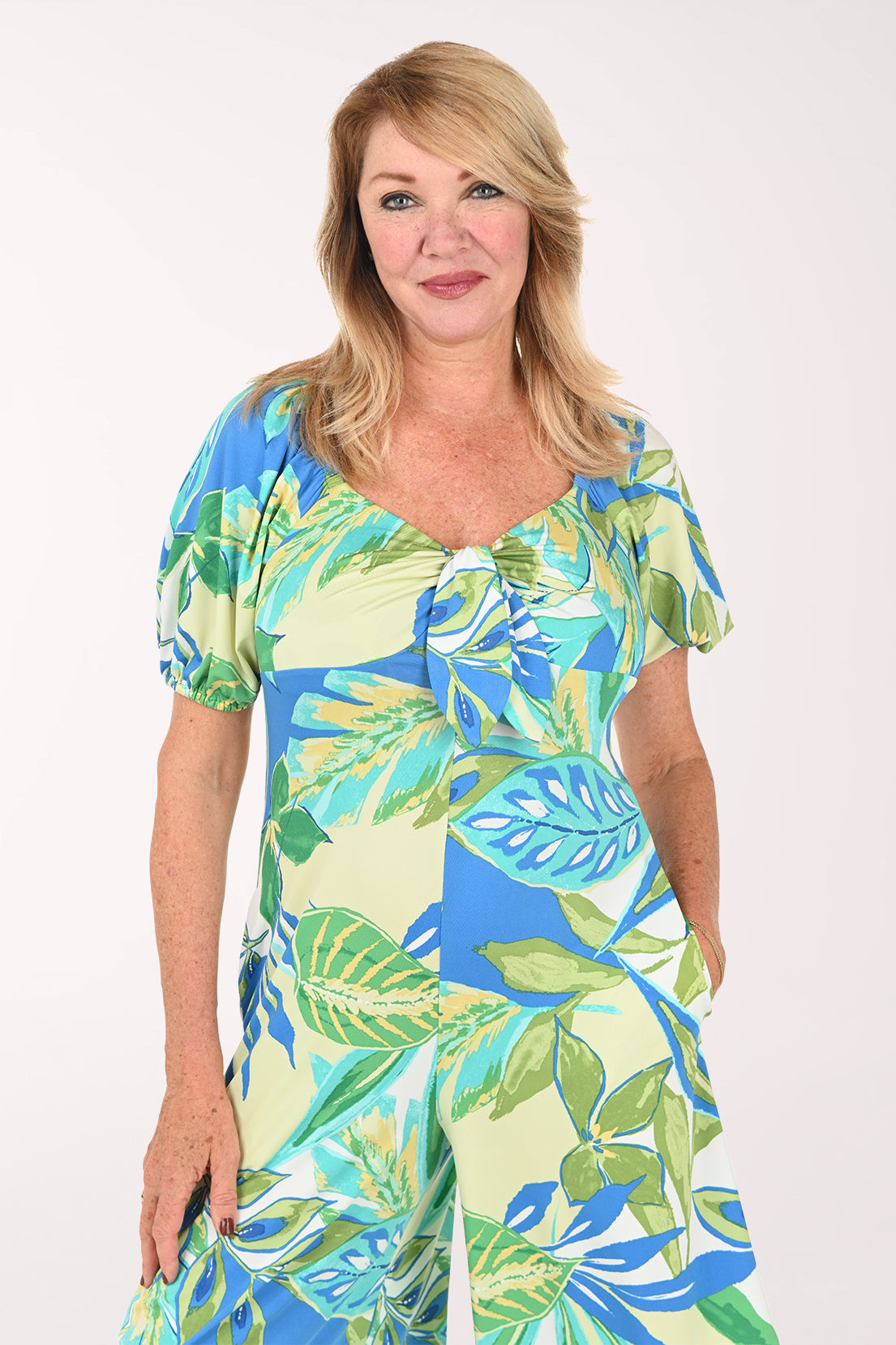 Woman wearing a multi colored jumpsuit with short puff sleeves