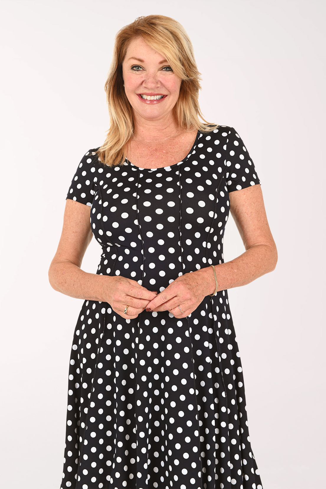 Woman wearing a short sleeve black and white polka dot dress