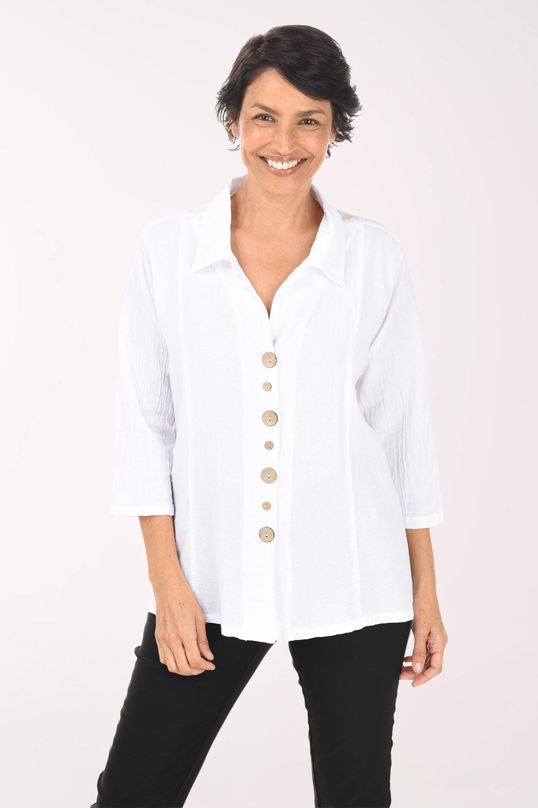 Woman wearing a white blouse with buttons on a white background