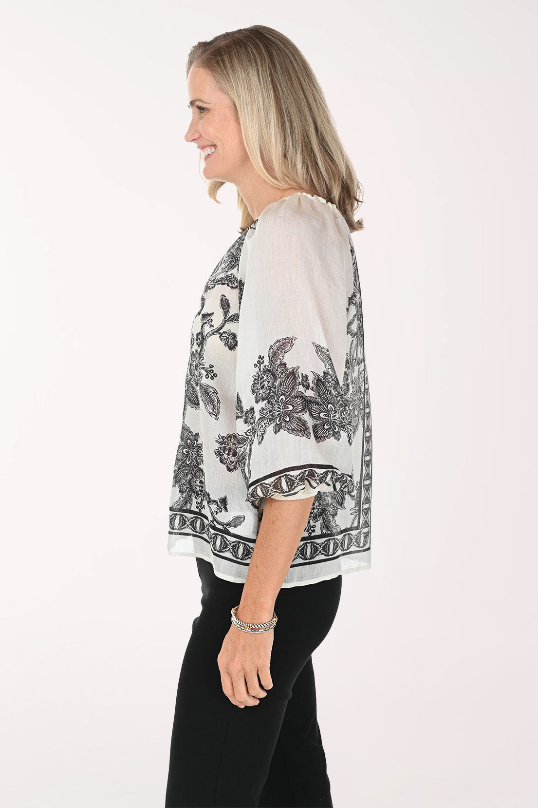 Woman wearing a patterned blouse with a white background