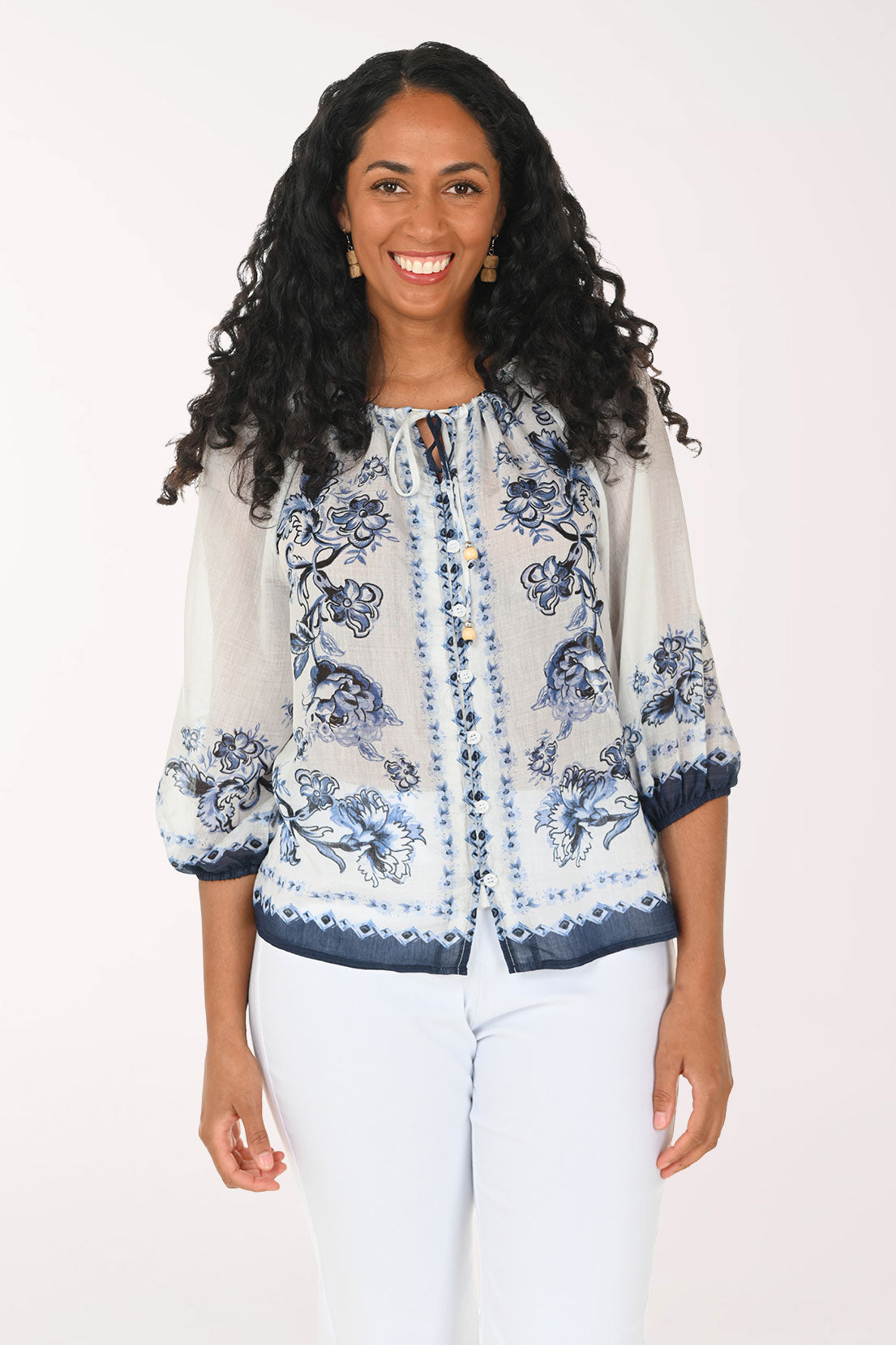 Woman wearing a floral blouse with a white background