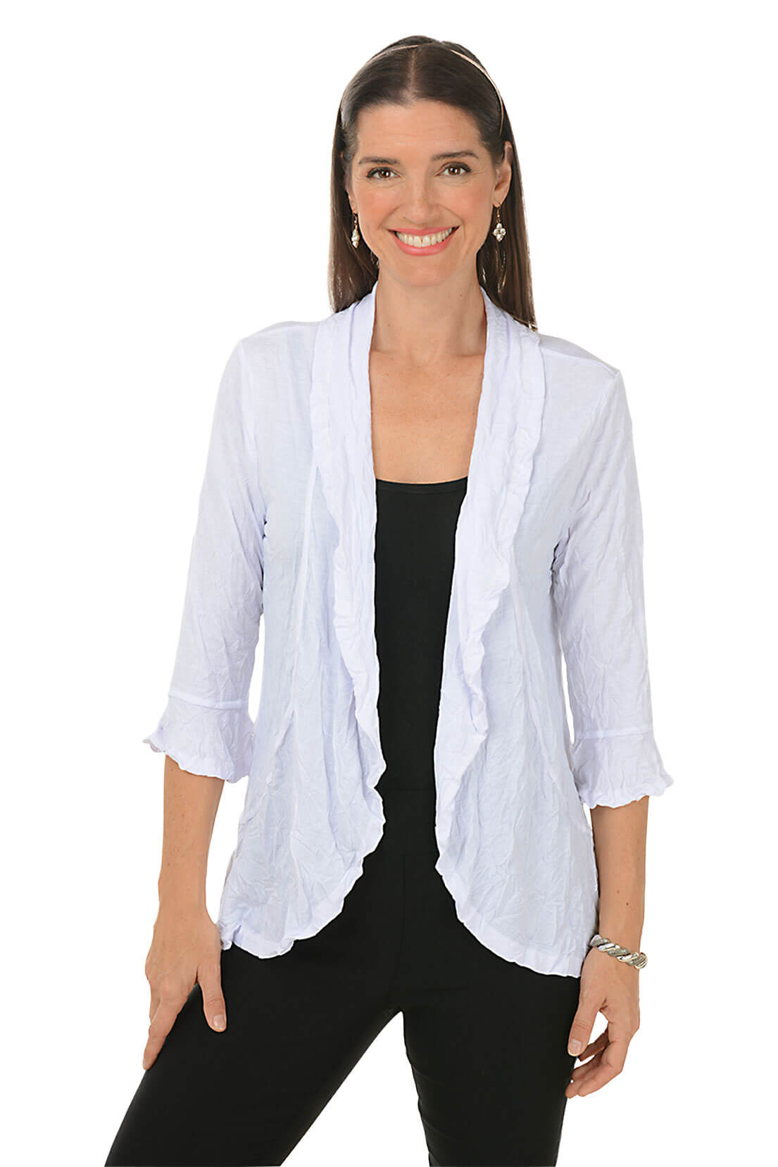 A front shot of a model wearing a white open front cardigan with bell sleeves over a black tee and black pants.