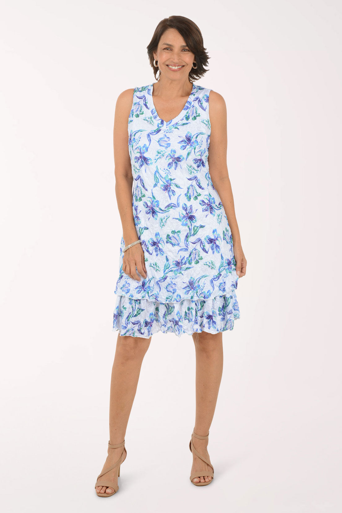 Woman wearing a blue floral dress on a white background